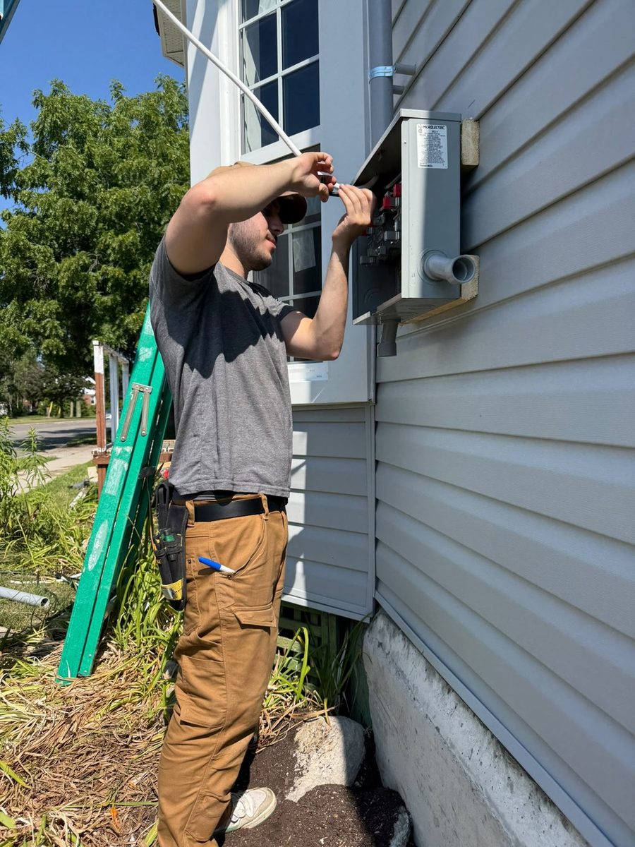 Licensed AM Services electrician working on a service
